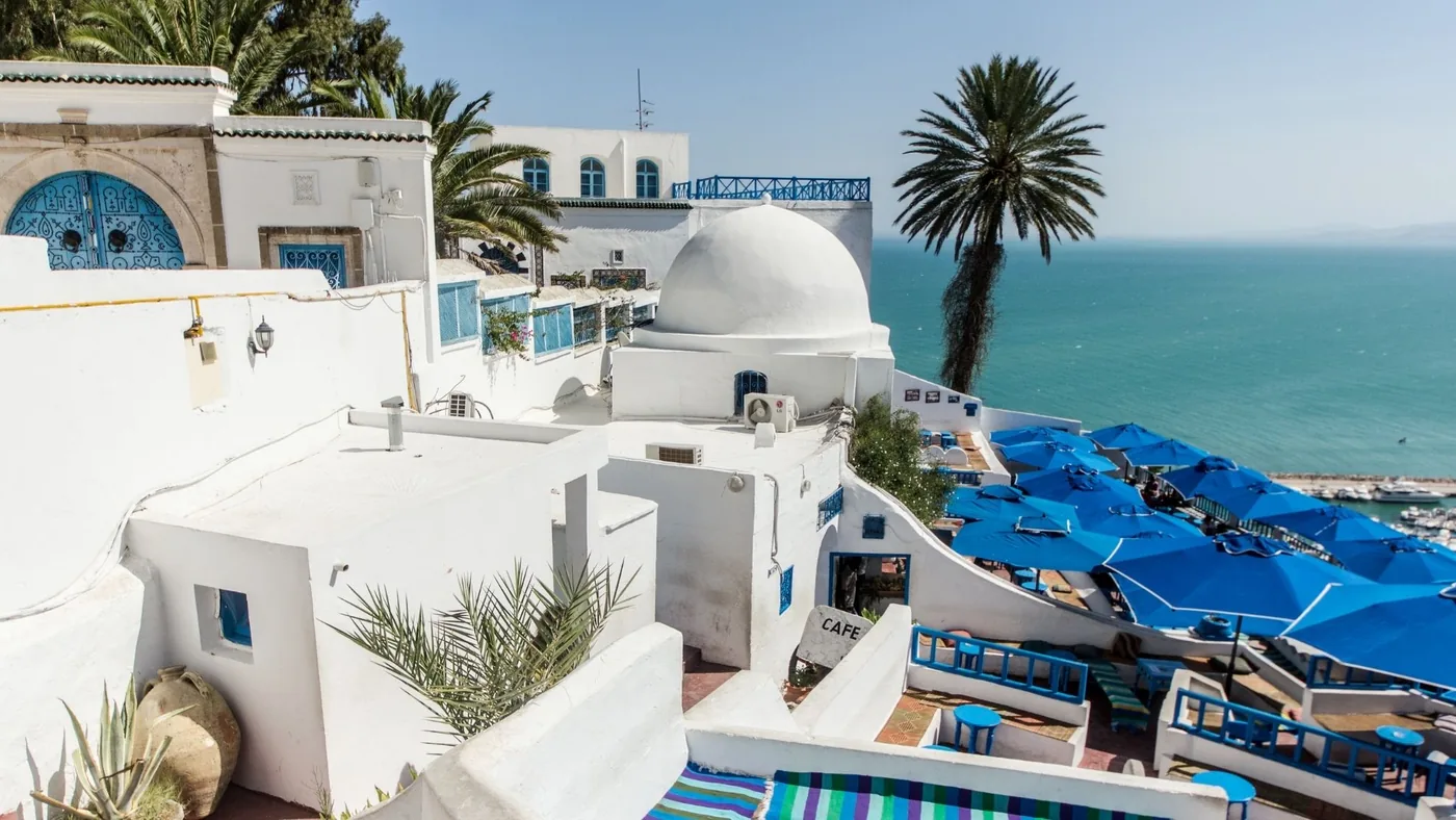 The rooftops of Sidi Bou Said with blue parasols and the Mediterranean beyond, ten minutes up the coast from Carthage