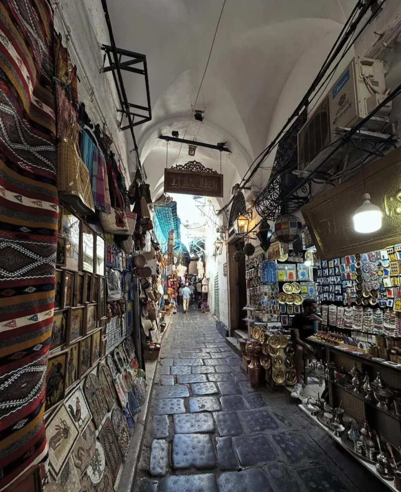 A vaulted souk arcade in the Medina of Tunis lined with stalls
