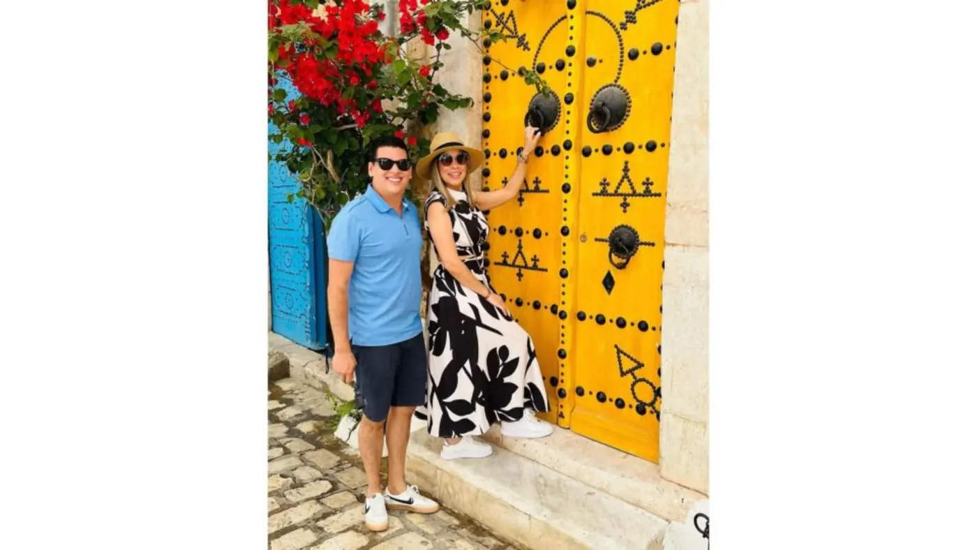 A studded yellow door in a whitewashed Sidi Bou Said lane